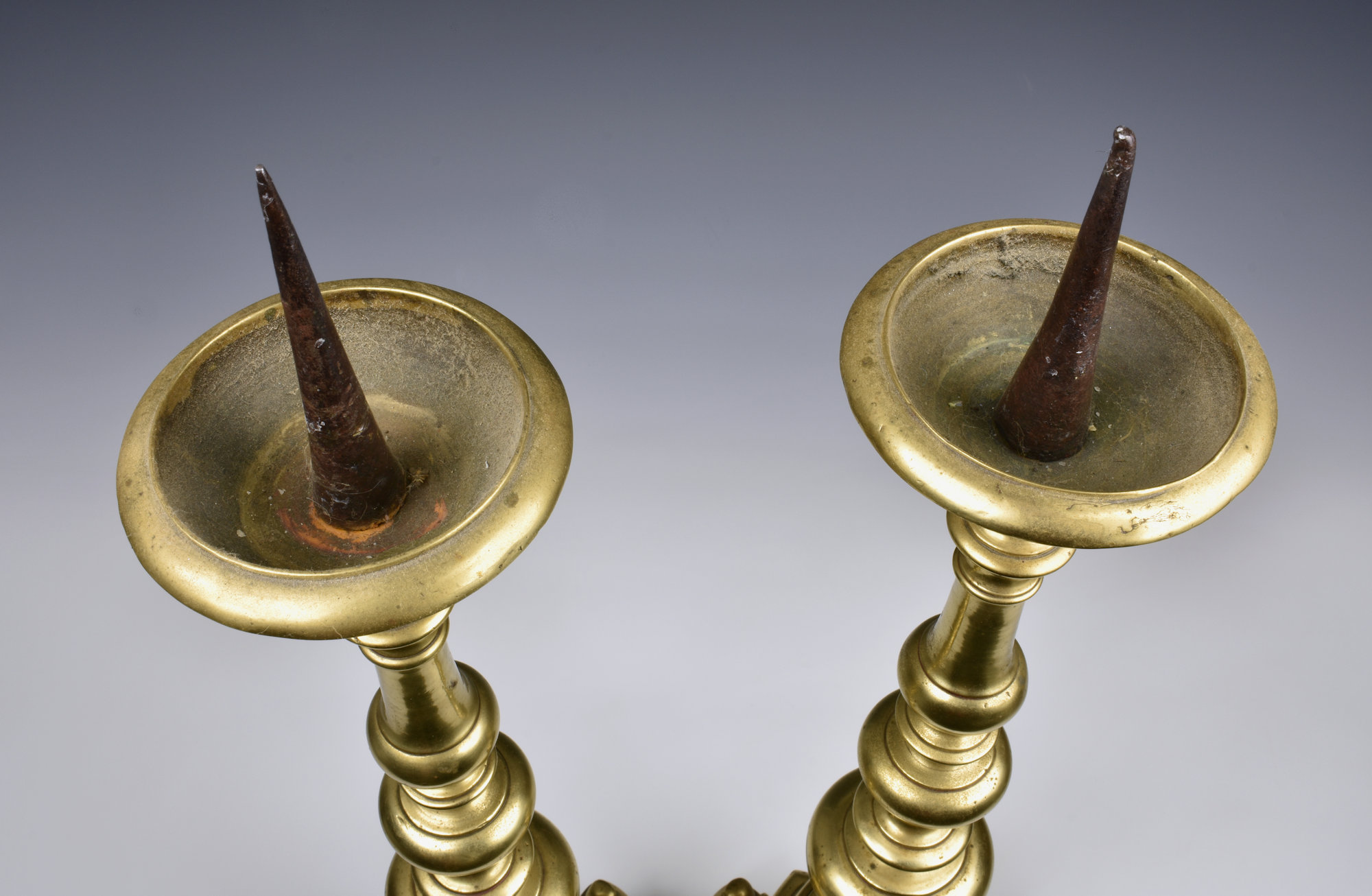 A pair of 17th / 18th century Flemish brass pricket candlesticks each with a circular drip pan - Image 3 of 6