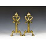 A pair of Victorian brass fleur-de-lys fire dogs standing 13½in. (34.2cm.) high. *Condition: One