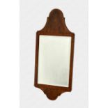 An Art Deco burr walnut and oak mirror in the Queen Anne style, the rectangular bevelled plate