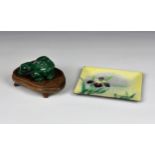 An Oriental carved malachite frog 2¾in. (7cm.) long, on a hardwood stand; together with a Japanese