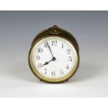 A small brass cased drum clock early 20th century, the Arabic enamel dial with bevelled glass,