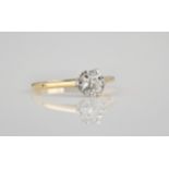 An 18ct yellow gold and diamond solitaire ring the brilliant cut diamond in a six claw setting, size