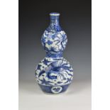 A Chinese porcelain blue and white double gourd vase and cover probably 18th / early 19th century,