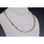 An 18ct white gold and diamond necklace and matching earrings the necklace with alternate polished