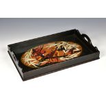 A Continental Art Deco lacquered tray 1930s, the ebonised tray with pierced handles and an oval