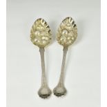 A pair of George IV silver berry spoons William Welch, Exeter 1822, with ornate shaped terminals,