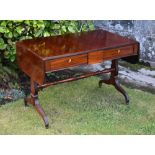 A late Regency mahogany sofa table the rounded rectangular dropflap top with reeded edge, over a