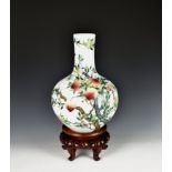 A Chinese porcelain famille rose baluster vase 20th century, with elongated neck on a hardwood