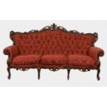 A Louis XV style carved and stained beechwood three piece settee suite comprising a three seater