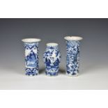 Three small Chinese porcelain blue and white vases comprising two sleeve vases, one painted with two
