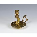 A 19th century French gilt bronze and champleve enamel chamberstick the urn sconce carried by a