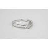 An 18ct white gold and diamond ring the centre brilliant cut diamond, approx. 0.25ct, over tapered