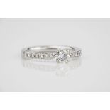 An 18ct white gold and diamond ring the central brilliant cut diamond, approx. 0.25ct over diamond