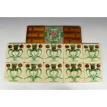 A set of ten Art Nouveau tiles the ivory glazed square tiles with stylised poppy decoration, moulded