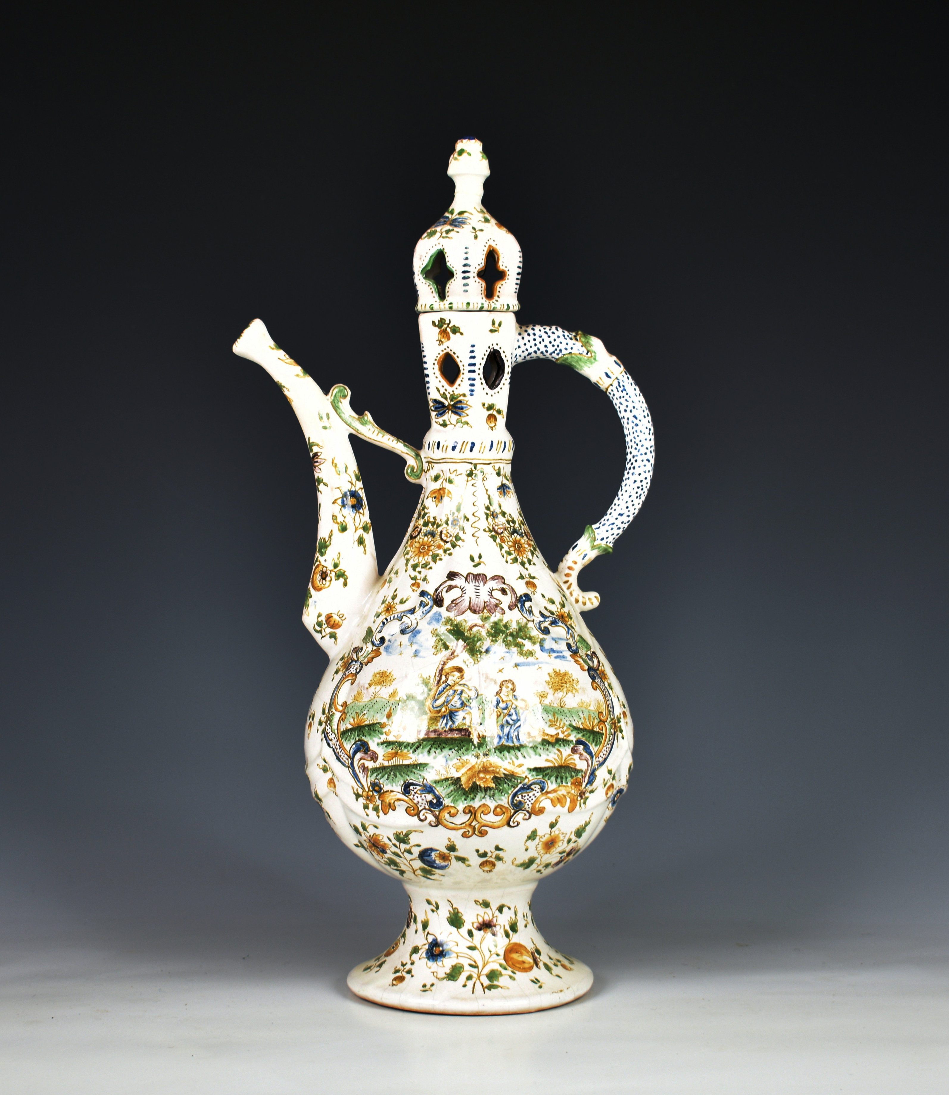 A faience lidded wine ewer of typical Islamic form the tapered teardrop body with slightly flared