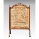 A French carved walnut firescreen c.1900, in the Louis XVI style, the broken arch screen with