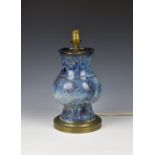 A Chinese porcelain flambe glazed lamp, the stoutly potted vase with a thick, streaked and mottled