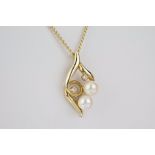A 9ct gold, pearl and diamond pendant the leaf shaped openwork pendant set with two brilliant cut