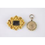 A Victorian 18ct gold mourning brooch of shaped diamond form with scroll and rocaille decoration,