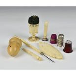 A small collection of antique and vintage sewing accessories comprising a small group of bone