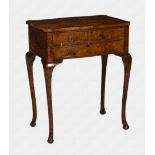 A walnut three drawer side table 1920s, the partially faux-grained burr walnut veneered and