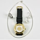 A Juicy Couture ladies gold plated quartz wrist watch with white and gold crystal set dial and black
