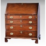 A George III mahogany bureau the fall front enclosing a fitted interior with green gilt tooled