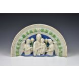 An Italian Cantagalli plaque in the manner of Della Robbia, glazed terracotta, of arched from,