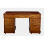 An Edwardian mahogany double pedestal desk the caddy moulded top with inset gilt tooled red leather,