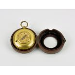 A red leather cased gilt metal travelling pocket barometer and compass combination early 20th