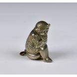 A novelty nickel plated vesta case circa 1900, depicting a boy seated upon a bed pan, with glass