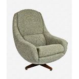 A retro 1960s-70s revolving easy chair upholstered in hand-knitted green-grey wool, on a sprung
