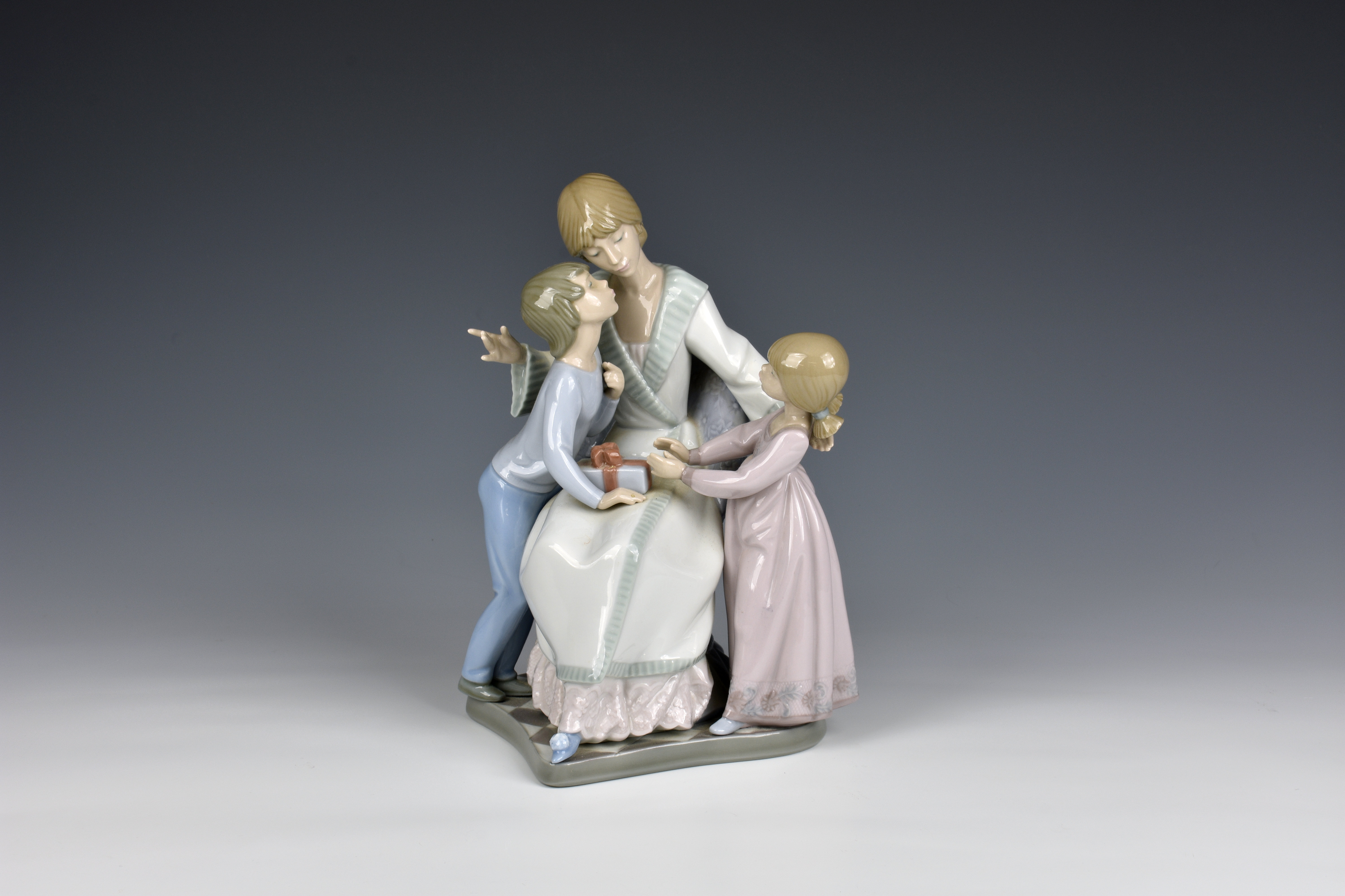 A Lladro 5596 Gift of Love porcelain figural group with blue printed and impressed factory marks,