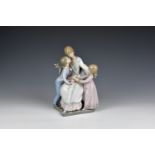 A Lladro 5596 Gift of Love porcelain figural group with blue printed and impressed factory marks,