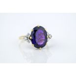 An 18ct yellow gold, amethyst and diamond ring hallmarked 1978, the oval cut amethyst of fine