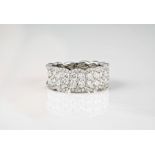 An 18ct white gold and diamond half eternity ring the wide, scalloped band set with two rows of