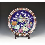 A large Japanese porcelain charger early 20th century, the central well decorated with two pheasants