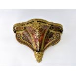 A mid-19th century Boulle clock bracket of deep serpentine form, with concave insets to the scroll