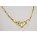 An 18ct two colour gold and diamond necklet and earrings set the v-shaped pendant with two rows of