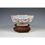 A 19th century Chinese porcelain Mandarin bowl decorated with two panels of figures outside a