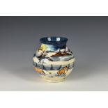 A Moorcroft Woodside Farm pattern baluster vase dated 1999, decorated with foxes in a snowy