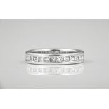 An 18ct white gold and diamond full eternity ring channel set with twenty eight princess cut