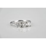 An 18ct white gold and diamond three stone ring the brilliant cut diamonds totalling 1.47ct, size M.