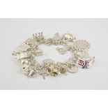 A silver charm bracelet fancy link, with various charms, including Channel Islands charms.