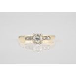 A mid-century 18ct yellow gold and diamond ring the central brilliant cut diamond over diamond set