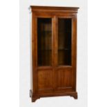 A French cherrywood glazed cabinet 20th century, the flared, ogee moulded top over a pair of