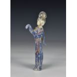A solid polychrome glass figure of a Chinese female dancer / actress standing with one arm raised
