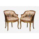 A pair of giltwood chariot-back bergère elbow chairs early 20th century, the shaped, moulded frame