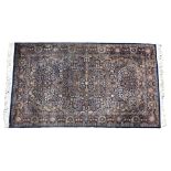 A Persian Isfahan style rug the central pendant medallion on a dark blue ground with all over