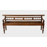 A Burmese colonial teak bench probably 19th / early 20th century, the low back rail over a triple